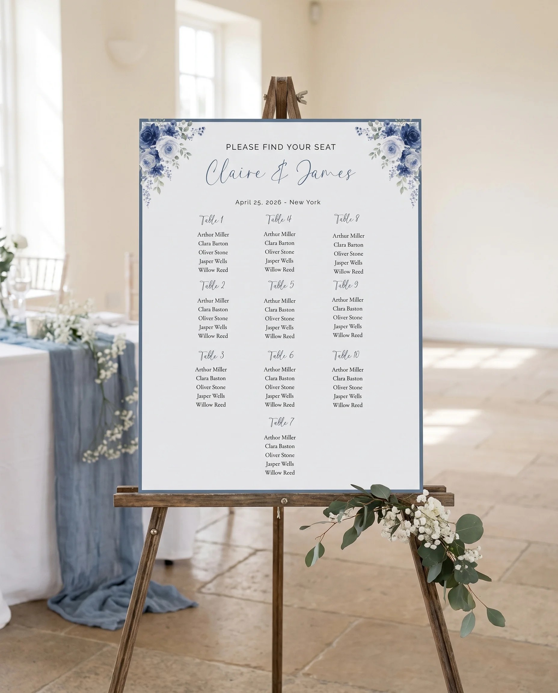 Bluebloom wedding seating chart — displayed on an easel under soft natural light with a slight overhead angle, wedding seating chart.
