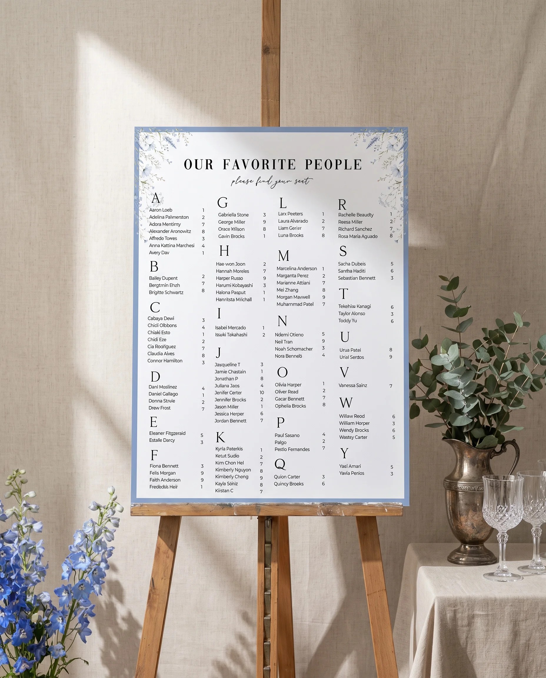Azure Sprig wedding seating chart — displayed on an easel under soft natural light at a slight overhead angle, wedding seating chart.