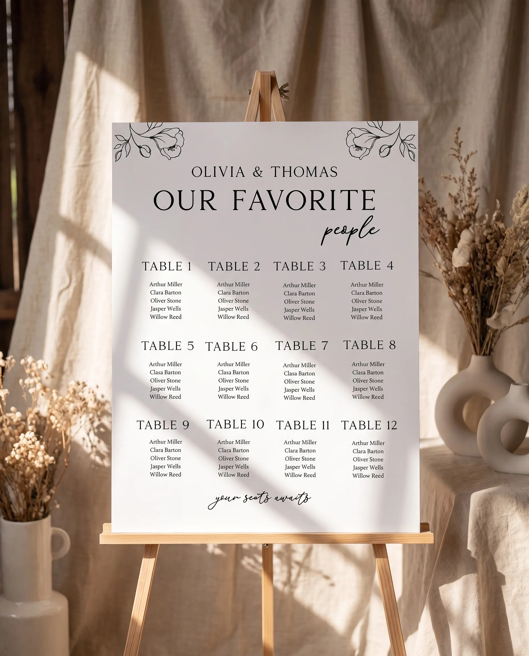 Meadow Sprig wedding seating chart — displayed on an easel under soft natural light with a slight overhead angle, wedding seating chart