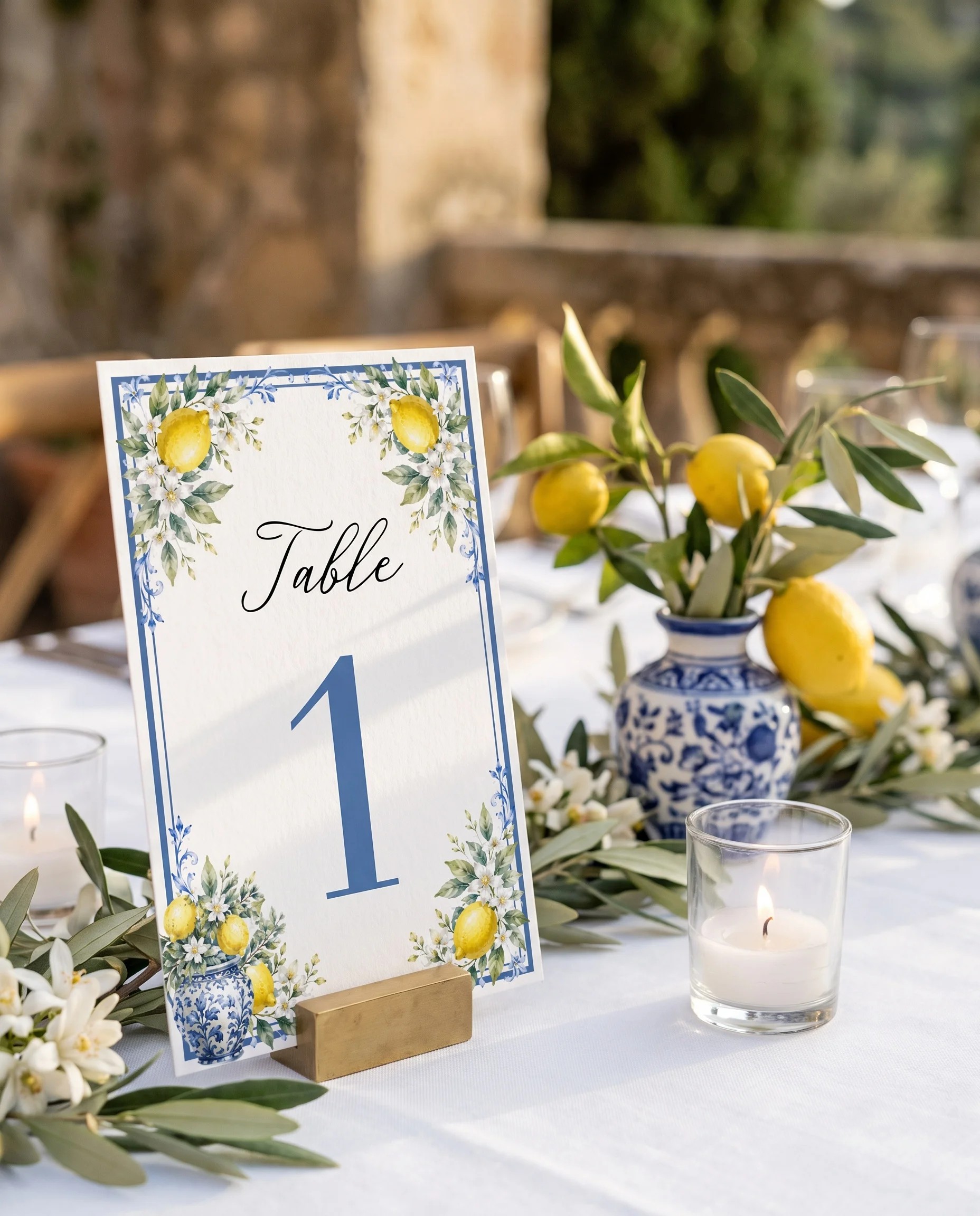 Amalfi Grove wedding table number — standing upright on a dressed table under soft natural light, slight overhead angle, table numbers wedding.