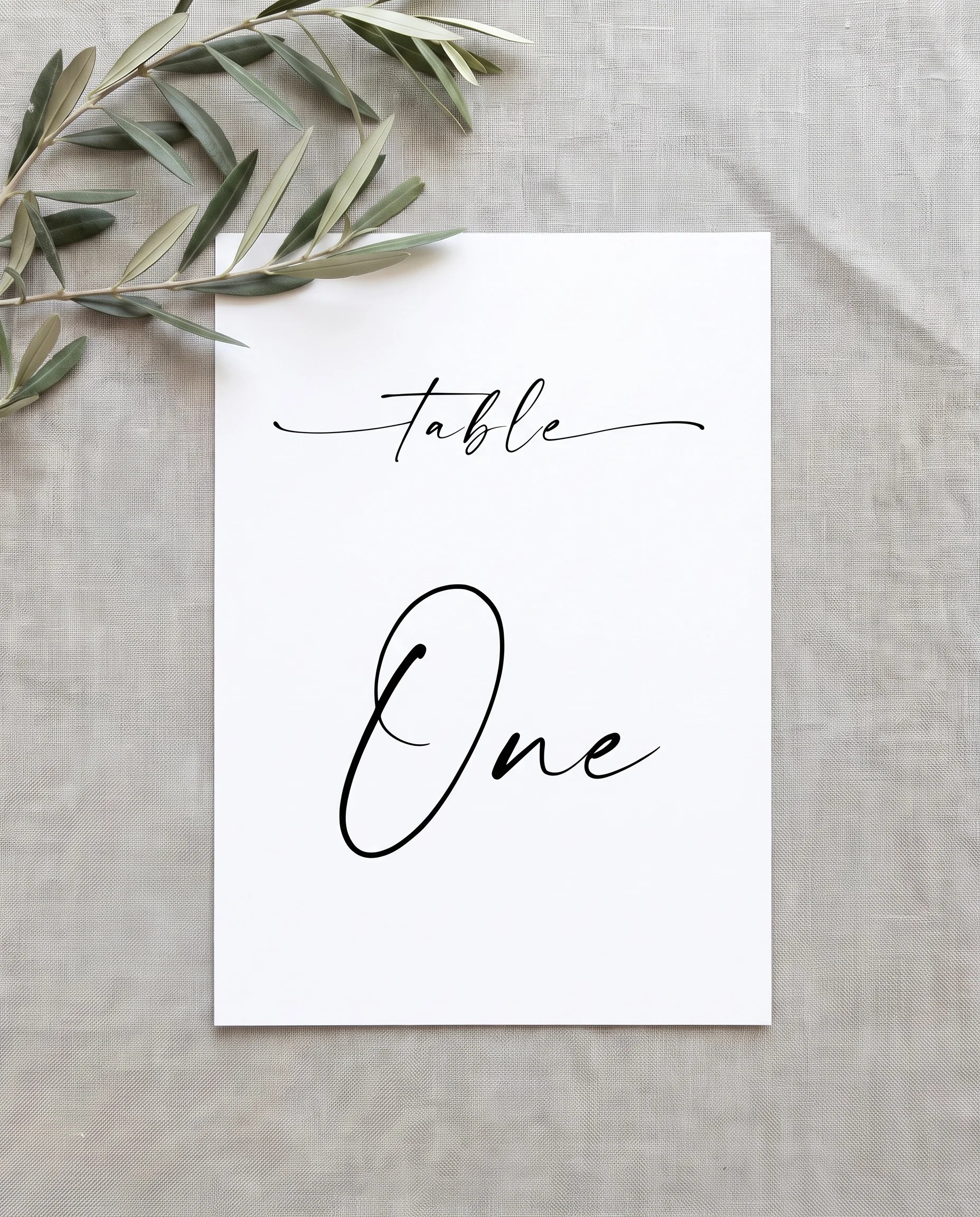 Liminal wedding table number — single card shown flat under soft natural light at a slight overhead angle, wedding table numbers