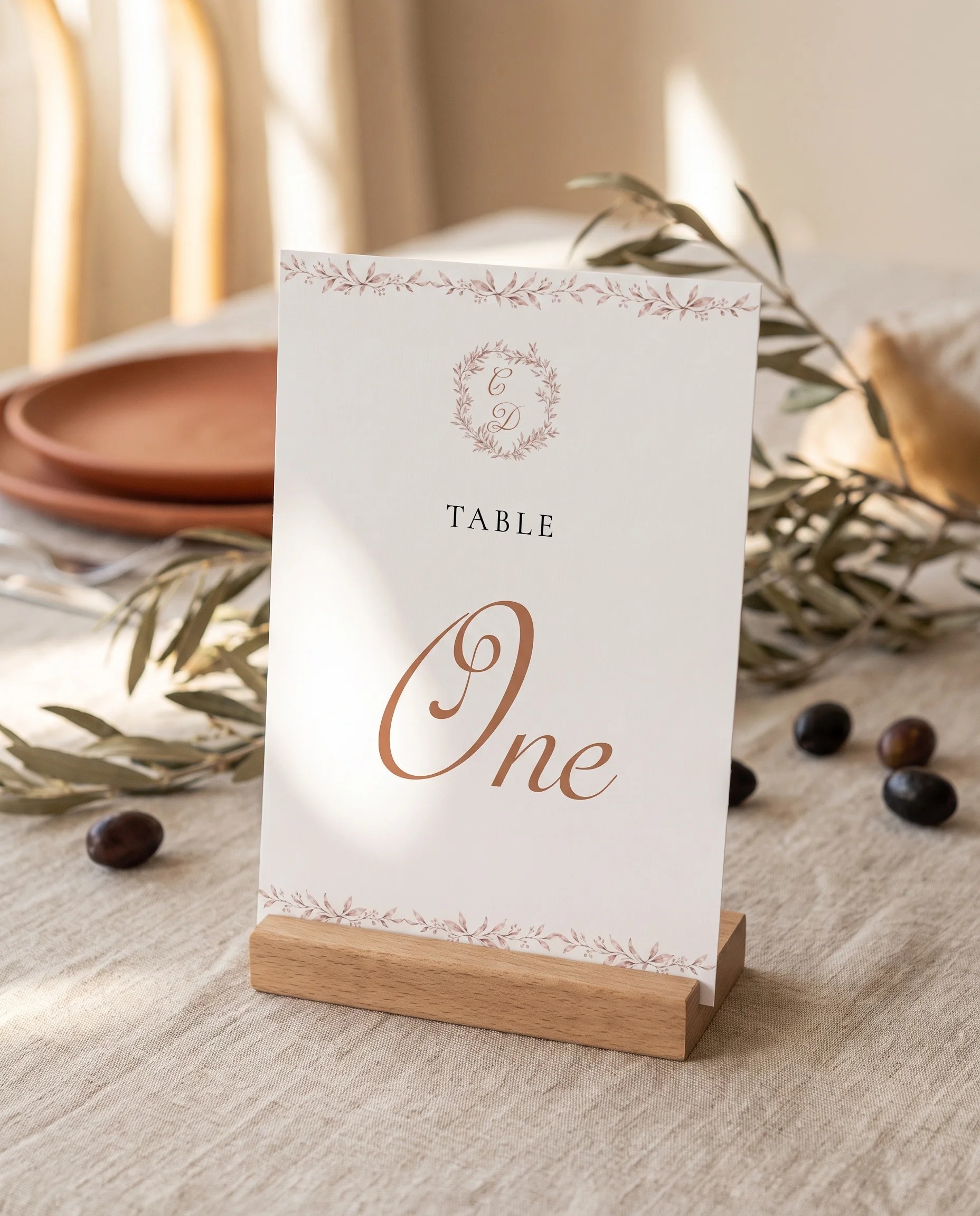 Sepia Sprig wedding table number — standing upright on a dressed table under soft natural light, table numbers wedding