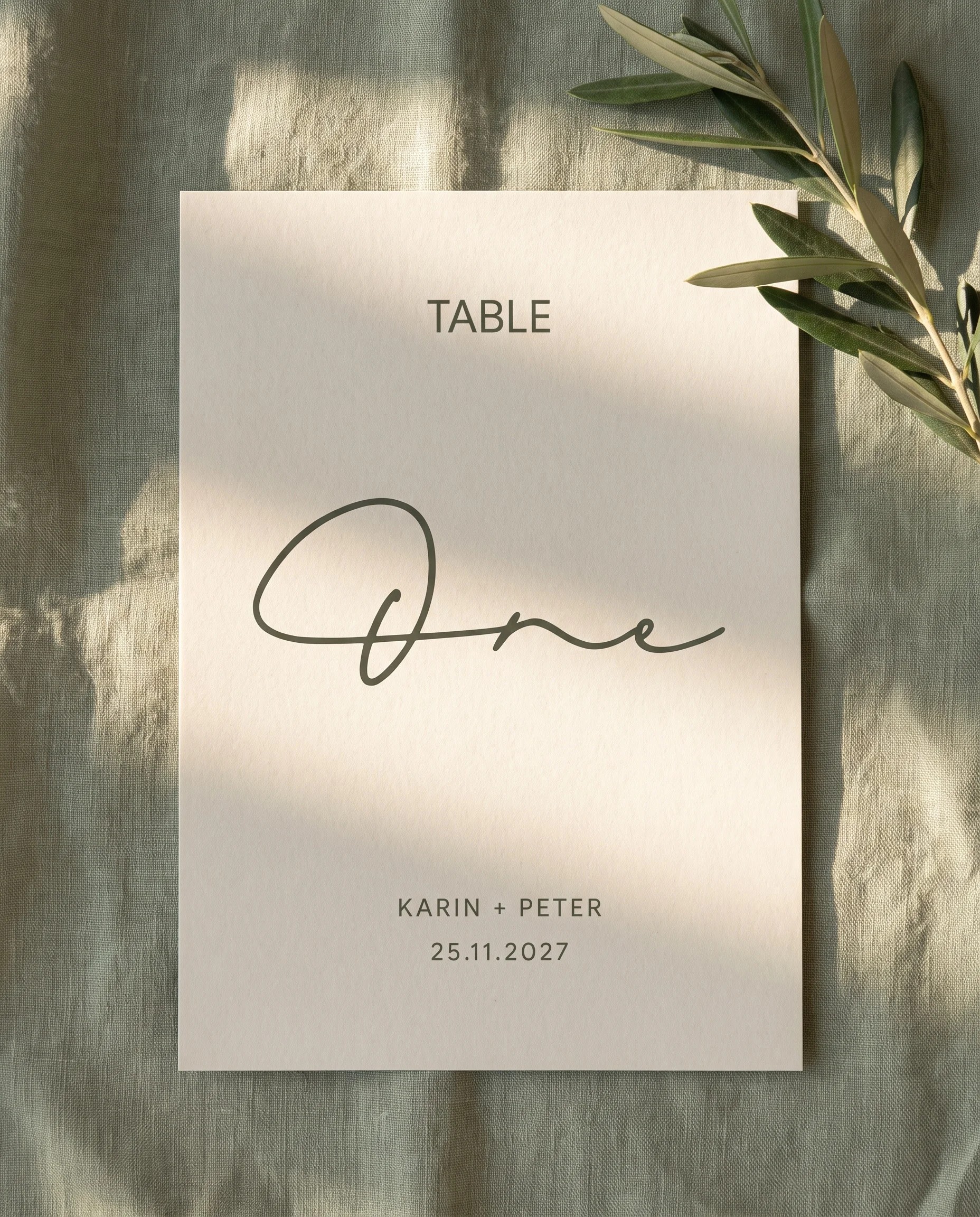 Manor Etching wedding table number — single card lying flat under soft overhead light on editorial paper, wedding table numbers.