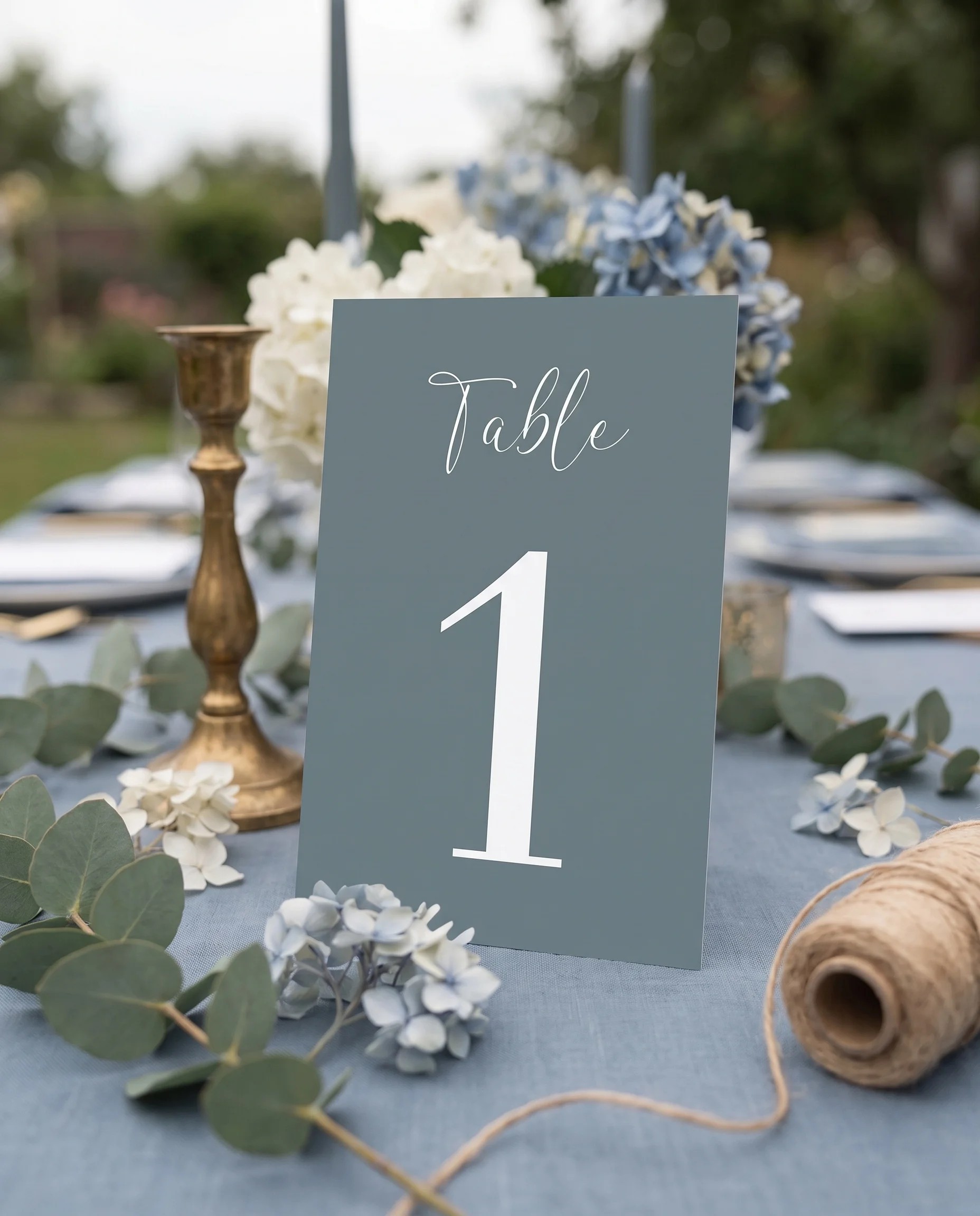 Arrow Crest wedding table number — standing upright on a dressed table under soft natural light, table numbers wedding