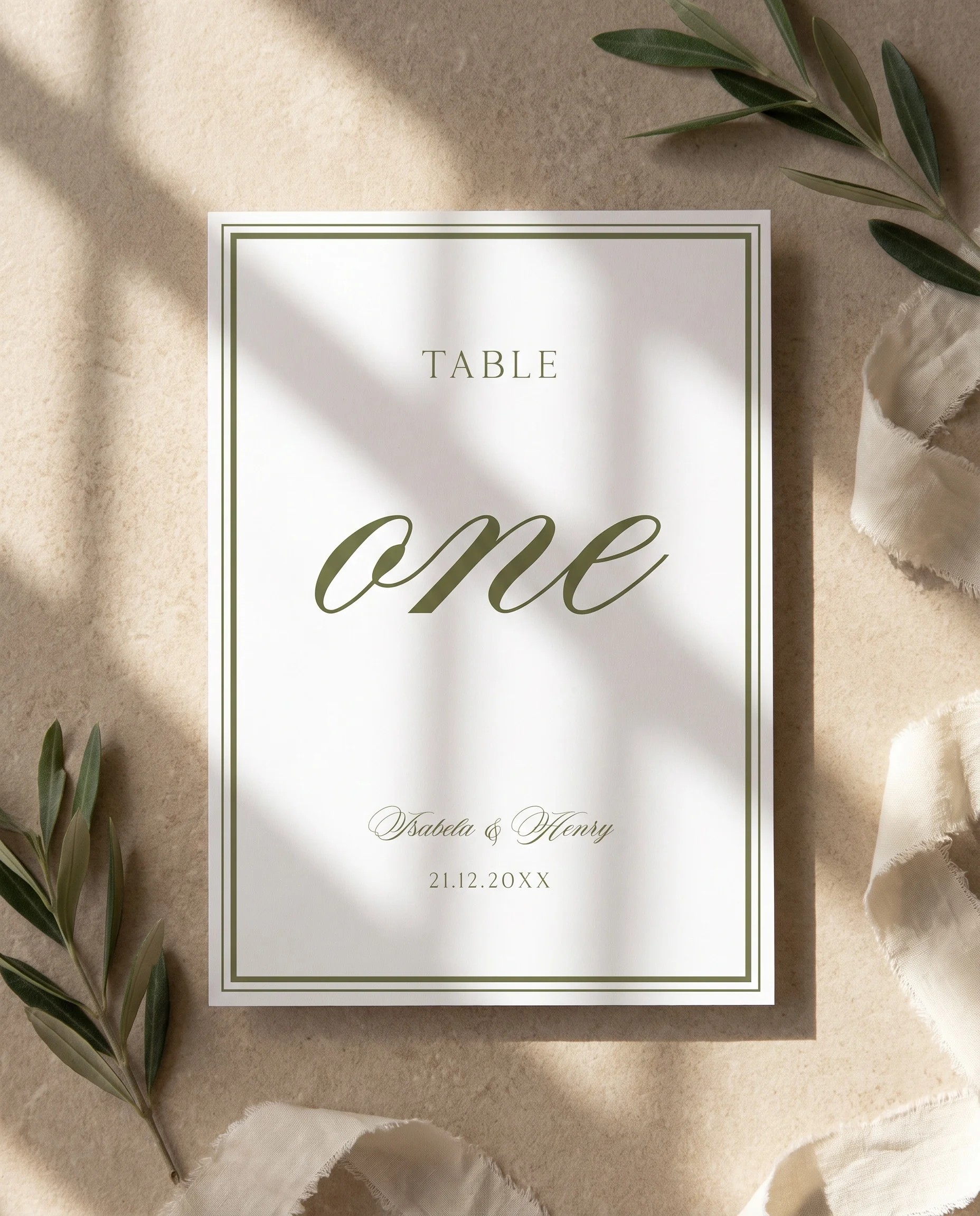 Olive Script wedding table number — flat lay view under soft natural light with a slight overhead angle, wedding table numbers