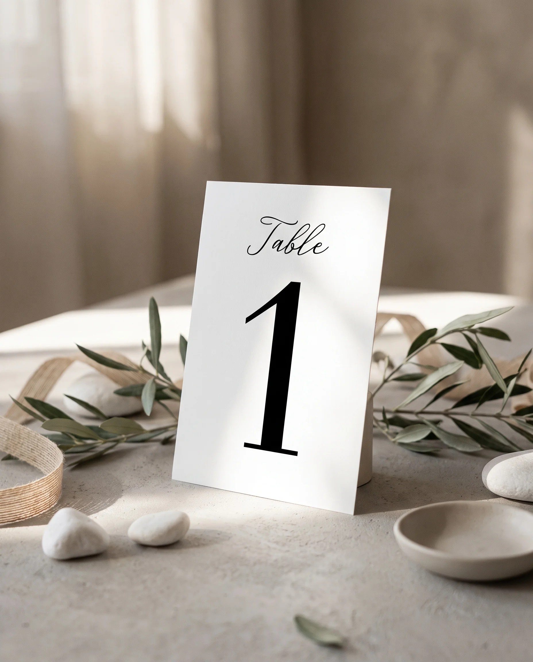 Lyris wedding table number — standing upright on a dressed table in soft natural light, table numbers wedding.