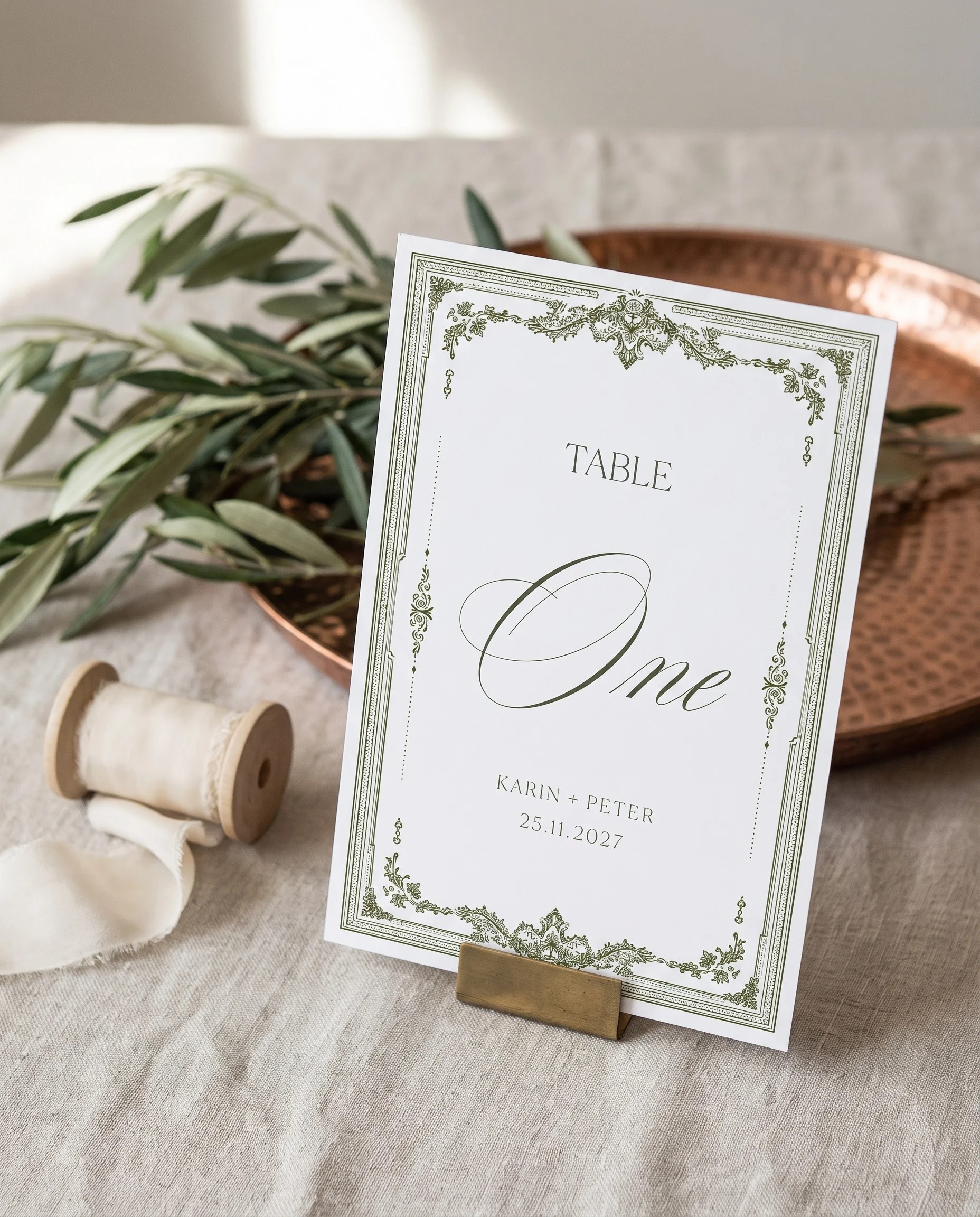 Verdant Filigree wedding table number — standing upright on a dressed table under soft natural light, captured from a slight overhead angle, table numbers wedding.