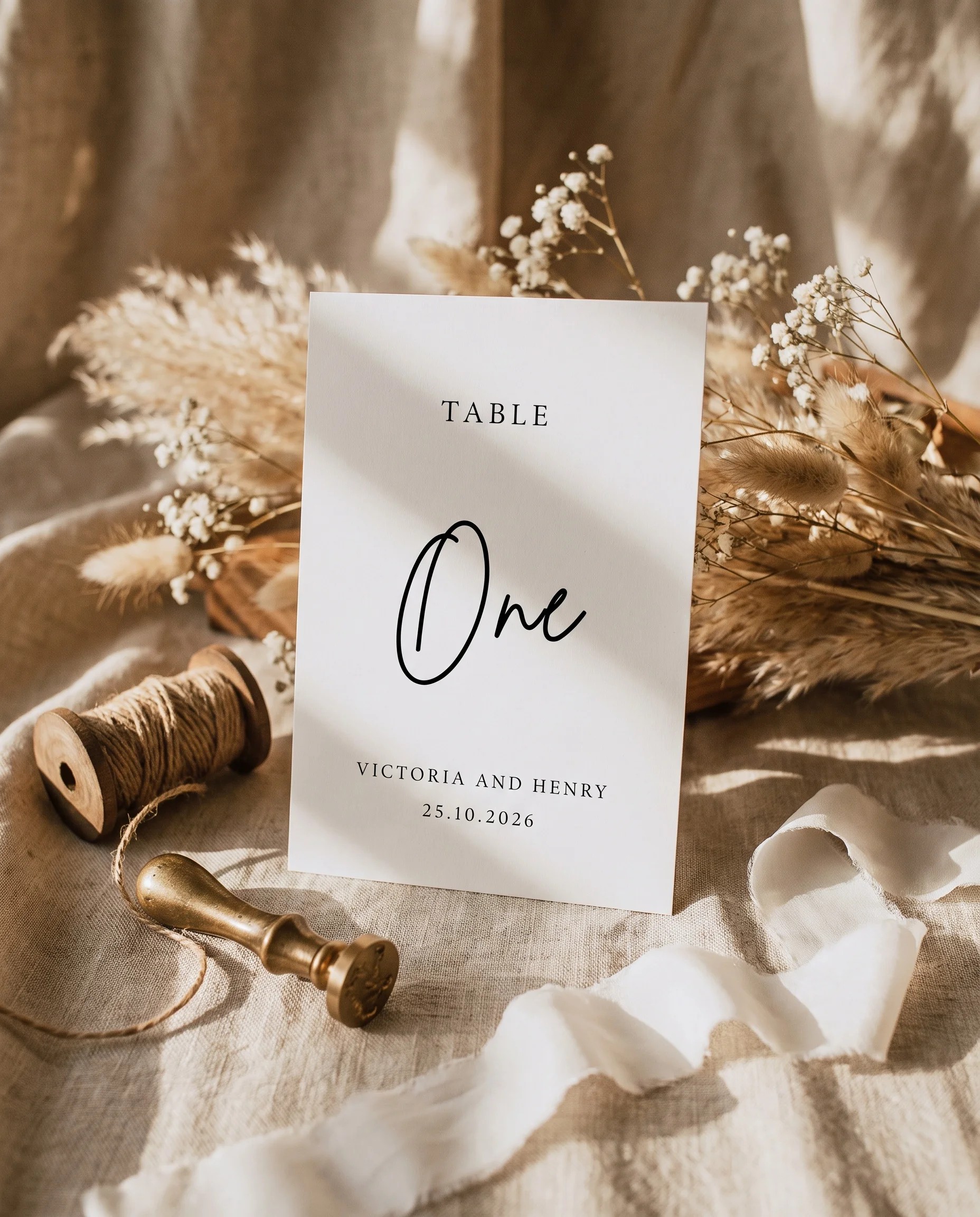 Arrowcrest wedding table number — standing upright on a dressed table under soft natural light, slight overhead angle, table numbers wedding.