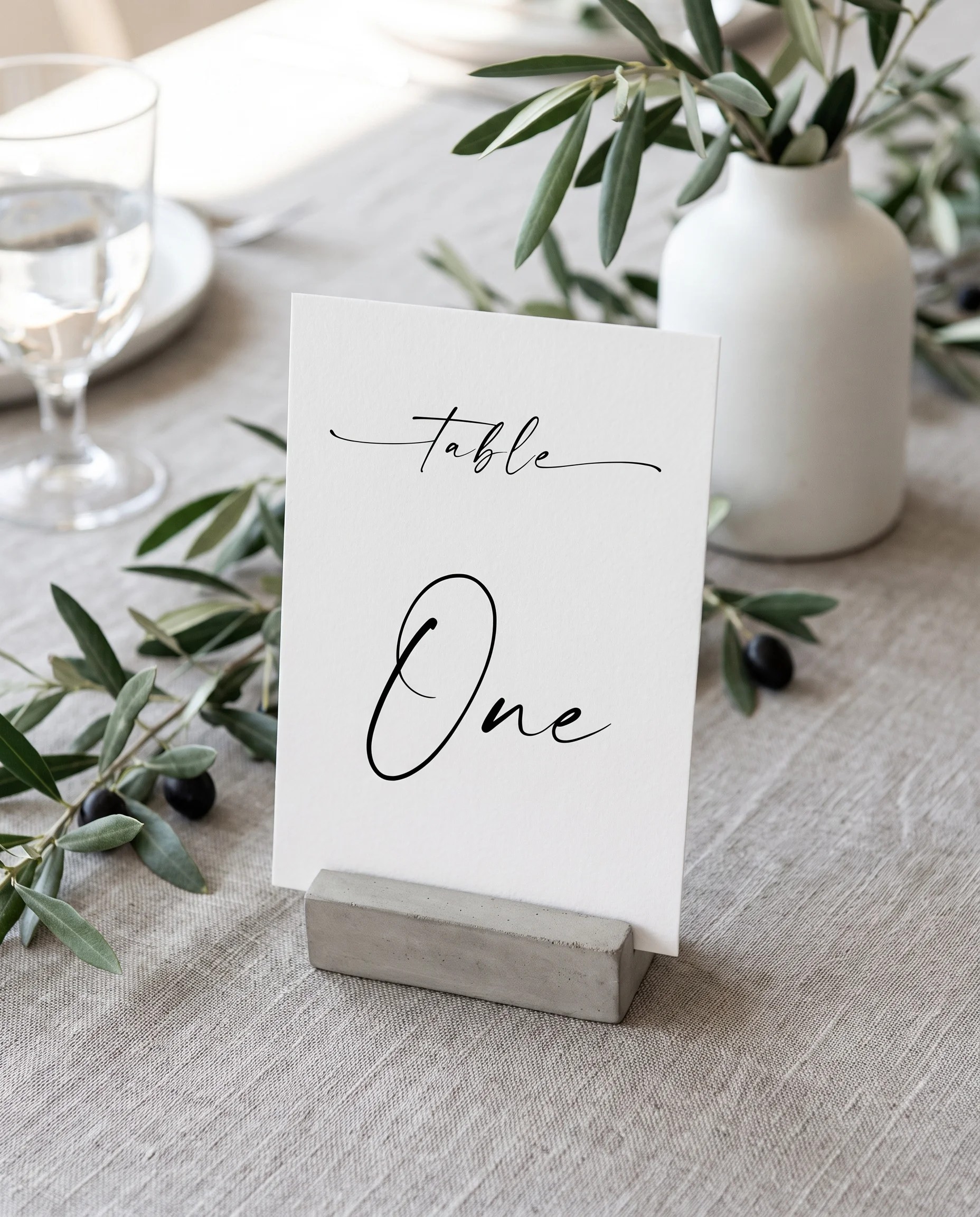 Liminal wedding table number — standing upright on a dressed table under soft overhead natural light, table numbers wedding.