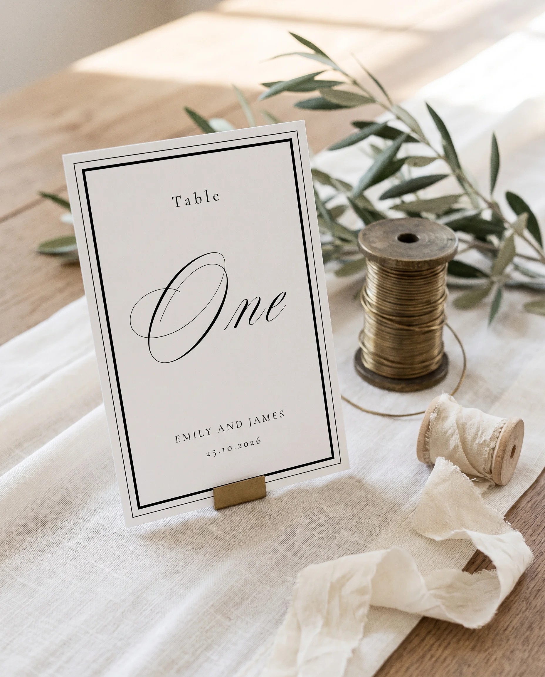 Heirloom wedding table number — standing upright on a dressed table under soft natural light, premium editorial table numbers wedding